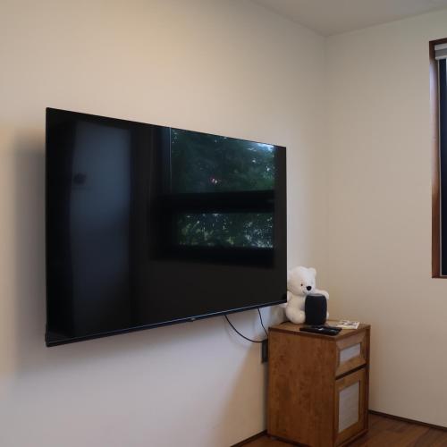 a large flat screen tv hanging on a wall at Yeongjingil 51 in Gangneung