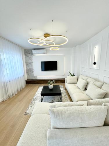 a living room with a white couch and a tv at Luxury Apartment Antoni in Podstrana