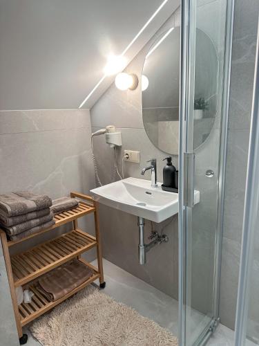 a bathroom with a sink and a shower at Vila Ambasada in Šventoji