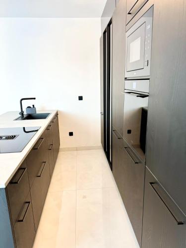 a kitchen with a sink and a refrigerator at Luxury Apartment Antoni in Podstrana