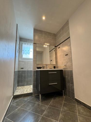 une grande salle de bain avec douche et lavabo dans l'établissement Rêve bleu, à Royan