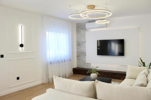 a living room with a couch and a tv at Luxury Apartment Antoni in Podstrana