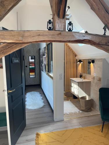 a room with an open door and a bathroom at Villa Ô Room in Chasnay
