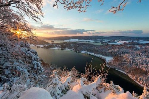 a view of a river in the snow at Studio cosy au cœur du Haut-jura in Foncine-le-Bas