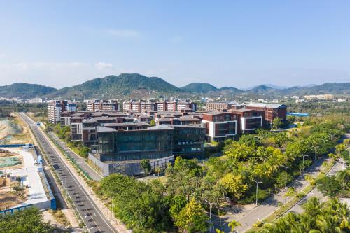 an aerial view of a city with trees and buildings at Sanya Haitang Bay Muyu Time Seaview Apartment in Sanya