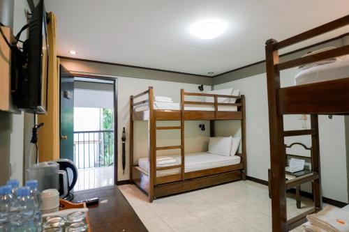 a room with two bunk beds and a table at Casa Basilisa Hotel & Resort in Guinobatan