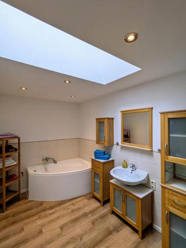 a bathroom with a bath tub and a sink at Ferienwohnung in Potsdam