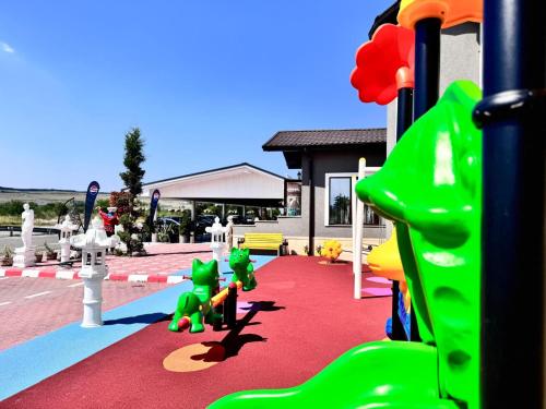 a childrens playground with a slide and toys on it at Hanul Domnesc Imperial Hotel & SPA in Călan