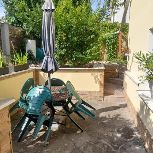 a patio with two chairs and an umbrella at Privat 2 na Sihoti in Trenčín
