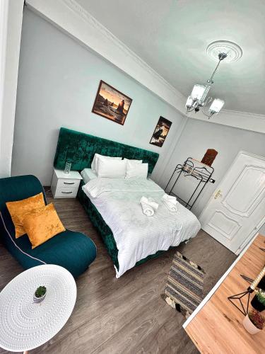a bedroom with a bed and a chair in it at Vila Darli Peshkopi Dibra in Peshkopi