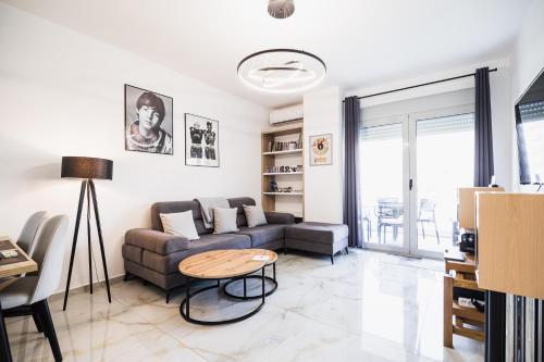 a living room with a couch and a table at Saranda Terraces Exclusive Appartment in Sarandë