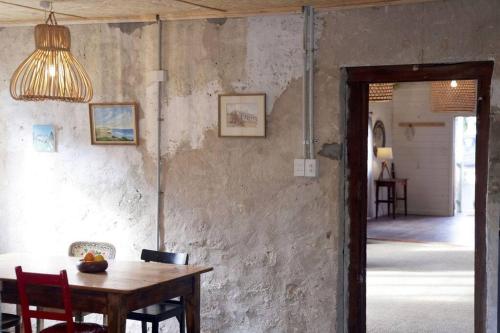 a dining room with a wooden table and a lamp at The Book Shop in Robe