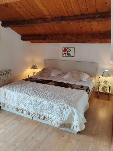 a bedroom with two beds and a wooden ceiling at Apartment in Lovran 34848 in Lovran