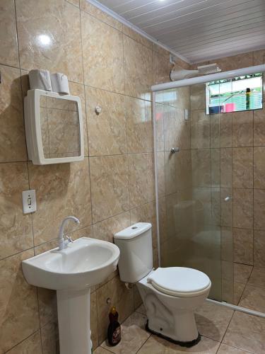 a bathroom with a toilet and a sink and a shower at Refúgio Serrano in Martins