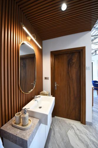 a bathroom with a white sink and a mirror at Casa de Monique Glamping Resort in Bogor