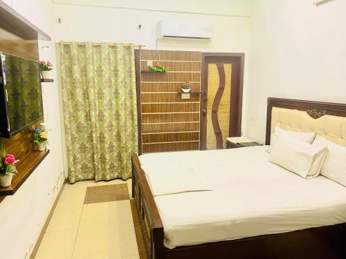 a bedroom with a large bed and a window at The Serena guest House in Hyderabad