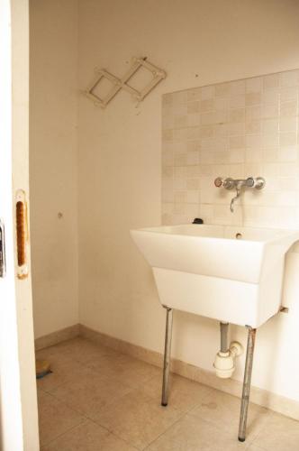 a bathroom with a white sink and a mirror at casa vacanze marinela in Casarano