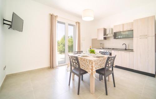 a kitchen and dining room with a table and chairs at Da Za Dichina in Realmonte
