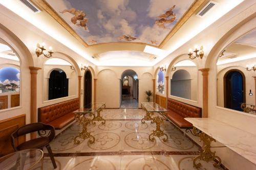 a large room with a ceiling with paintings on it at Dimora Cardinal Moroni in Rome