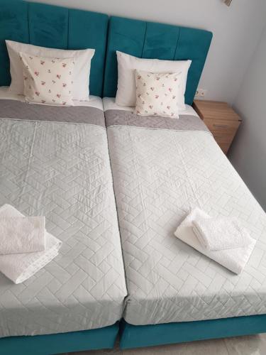 two beds with white and gray sheets and pillows at Villa P3 Paradise in Arménoi
