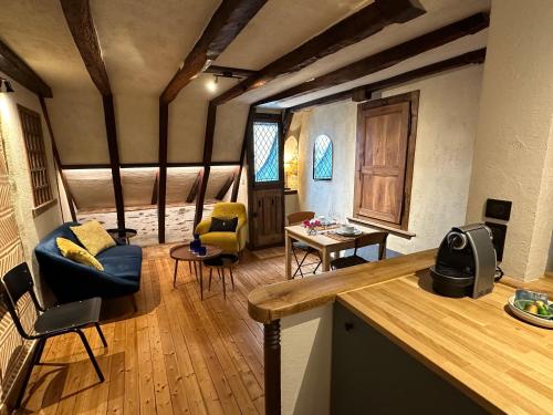 a kitchen and living room with chairs and a table at Le Petit Tinténiac - T2 cosy au cœur de la Doutre in Angers