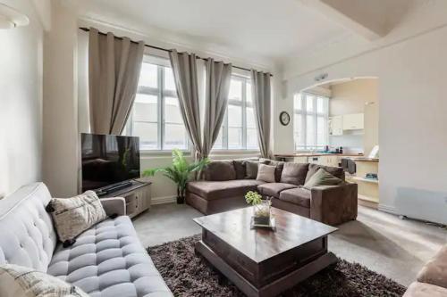 a living room with a couch and a coffee table at The Nest - Central and Sunny Wellington Loft in Wellington