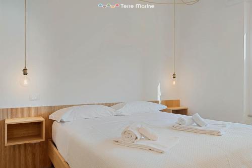 a bedroom with a bed with towels on it at Affittacamere Isabella, Terre Marine in Levanto