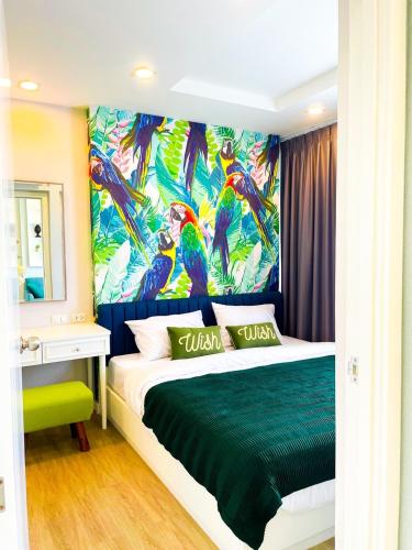 a bedroom with a peacock mural on the wall at Exclusive condo & Seaview in Ban Bang Saen (1)