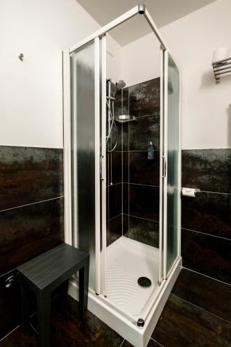 a shower stall with a bench in a bathroom at Hotel Cristallo in Rimini