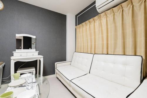 a living room with a white couch and a table at Super close to Dotonbori! Great location room#403 in Osaka