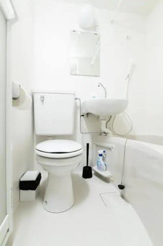 a white bathroom with a toilet and a sink at Super close to Dotonbori! Great location room#403 in Osaka
