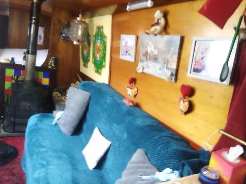 a blue couch sitting in a living room with medals at Rosie and Jim Retreat with hot tub indoors amazing in Lincoln
