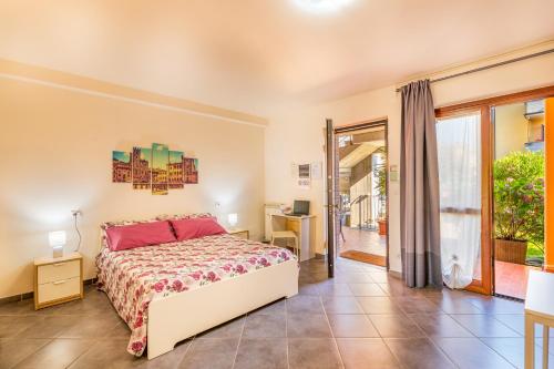a bedroom with a bed and a sliding glass door at Le Ortensie in Arezzo
