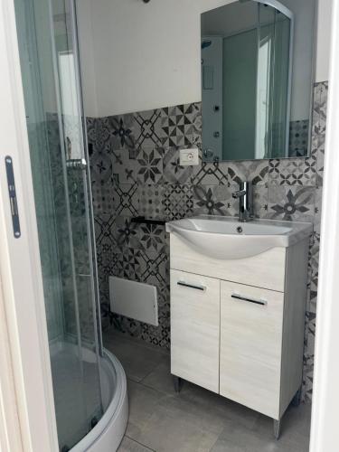 a bathroom with a sink and a shower at Civico 9 in Bonorva