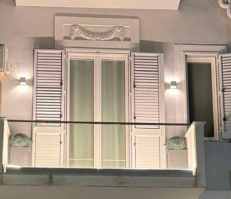 a building with a window with shutters on it at La Piazzetta a Mare Holiday House in Sferracavallo