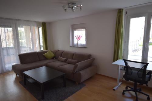 a living room with a couch and a table at Nestwerk Raumwunder K9-13 - Aufzug, viel Platz & am Wieland-Park in Biberach an der Riß