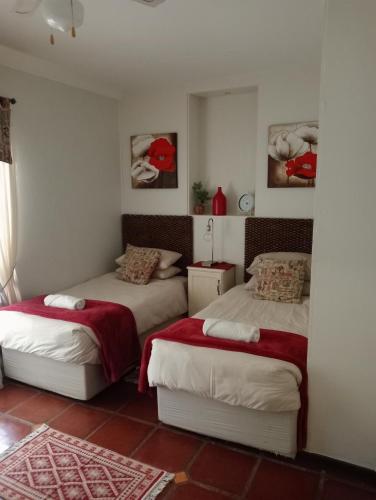 a bedroom with two beds in a room at A Cherry Lane Self Catering and B&B in Bloemfontein
