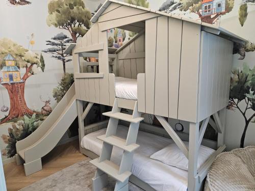 a wooden bunk bed in a childs room at L'Orée du Bois - Hôtel & Spa in Montagudet