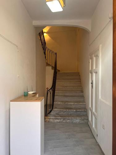 a hallway with a staircase and a stair case at Civico 9 in Bonorva