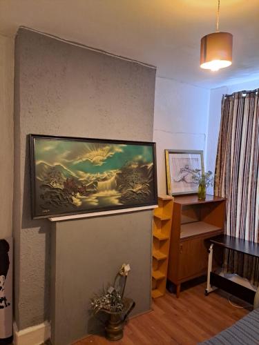a living room with a flat screen tv on a wall at London Smarty Rm in Thornton Heath