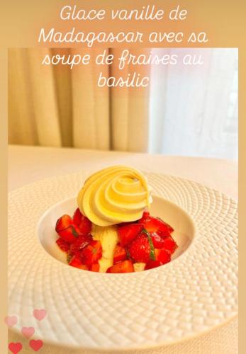 a dessert on a plate with fruit on a table at Le Clos Gabrielle in Châtellerault