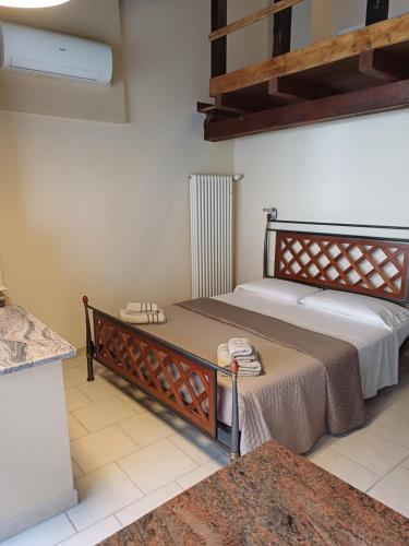 a bedroom with a large bed and a radiator at La Fortezza di Gavi - in Gavi