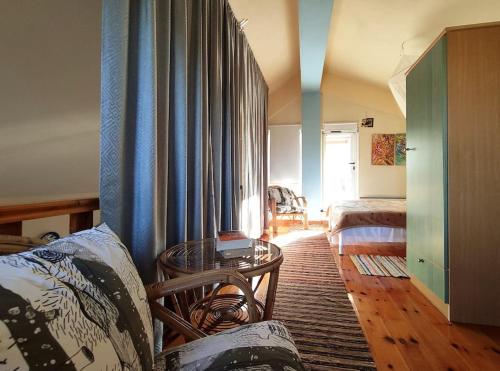 a living room with a couch and a table at Villa Loula google it in Lygia