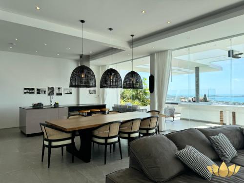 a kitchen and living room with a table and chairs at Golden Lotus Villas in Chaweng