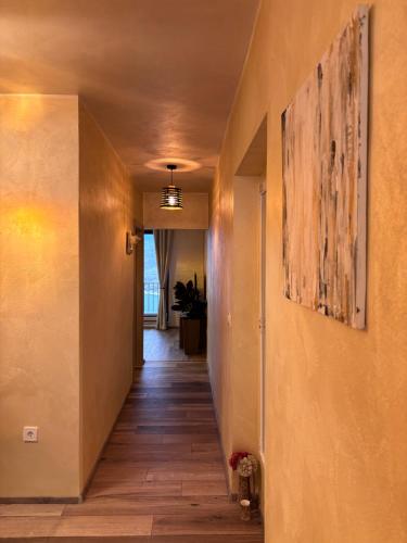 a hallway of a house with a painting on the wall at Amor, flat with private hot tub, breathtaking views and free parking in a garage, bookable all year round, Also take a look at our flat Coccolina in Rabac