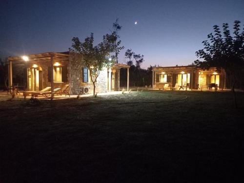 a house at night with the lights on at Petousis Villas in Galatás