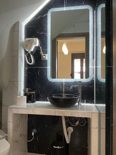 a bathroom with a sink and a mirror at Marinas House 2 in Skála Nikíta