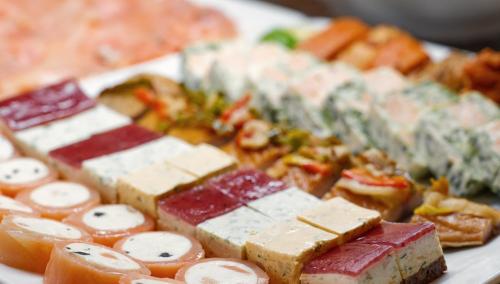 a plate of food with different types of cheese at Hotel Schluister Park in Carolinensiel