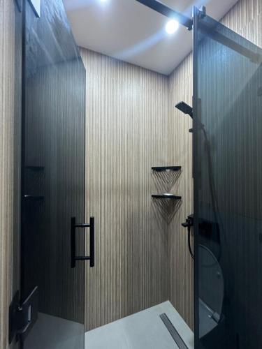a bathroom with a shower with a glass door at resting gonio in Gonio