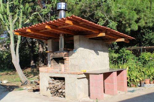 a brick oven with a roof on top of it at Villa Natina in Pizzo